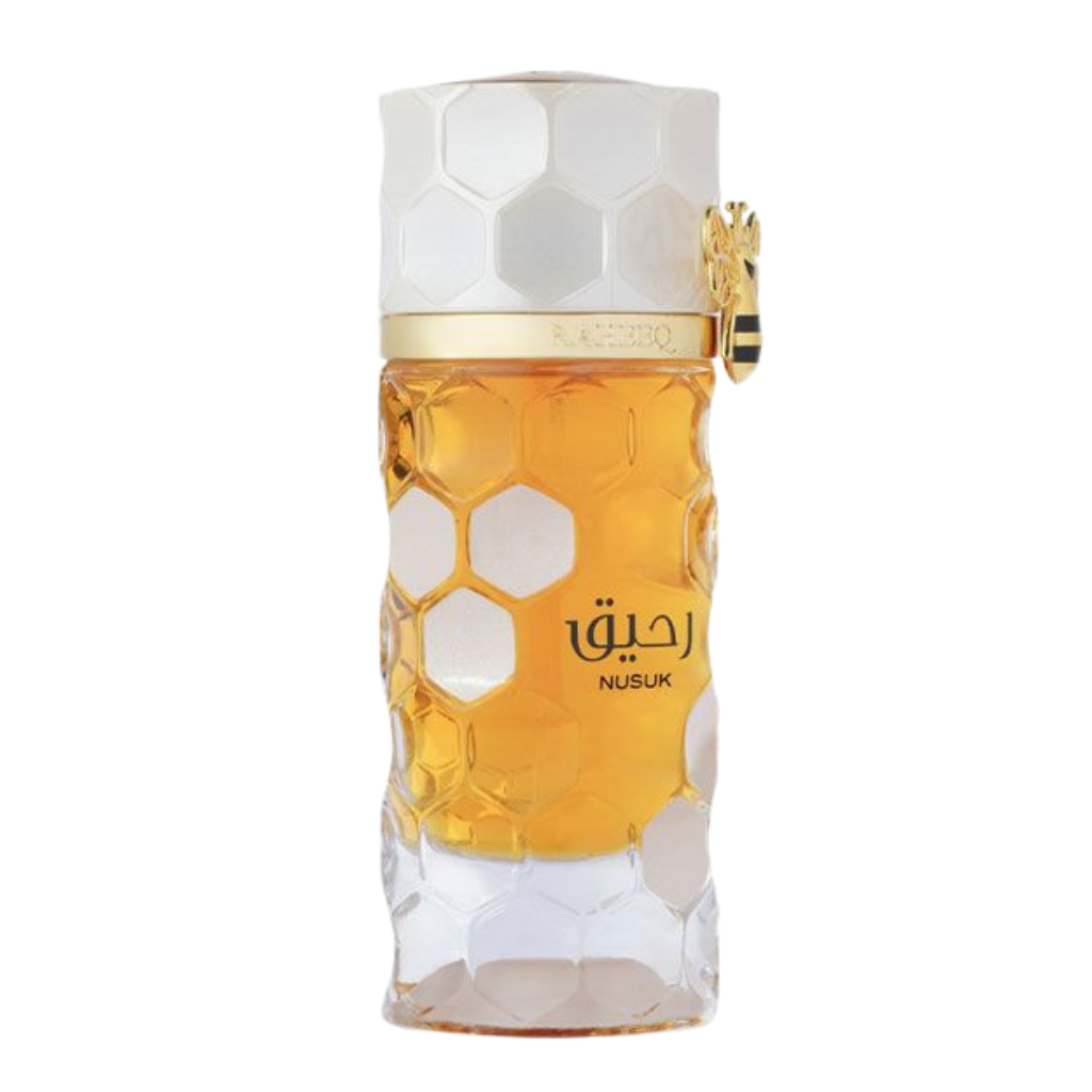Raheeq Extrait de Parfum bottle with honeycomb design and golden amber liquid inside, elegant luxury fragrance packaging.