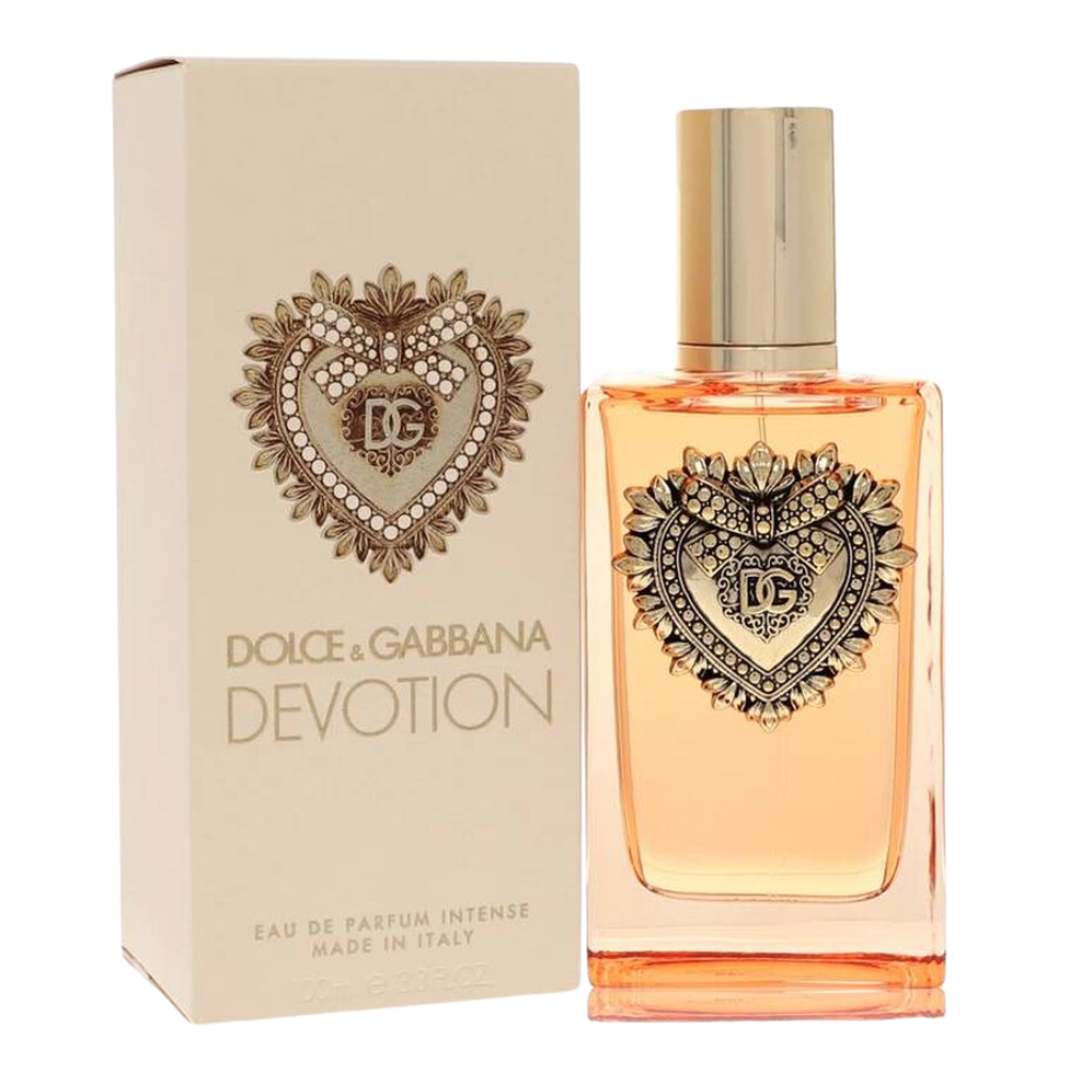 Elegant bottle and box of Devotion Intense For Women EDP with gold heart emblem and soft peach liquid inside
