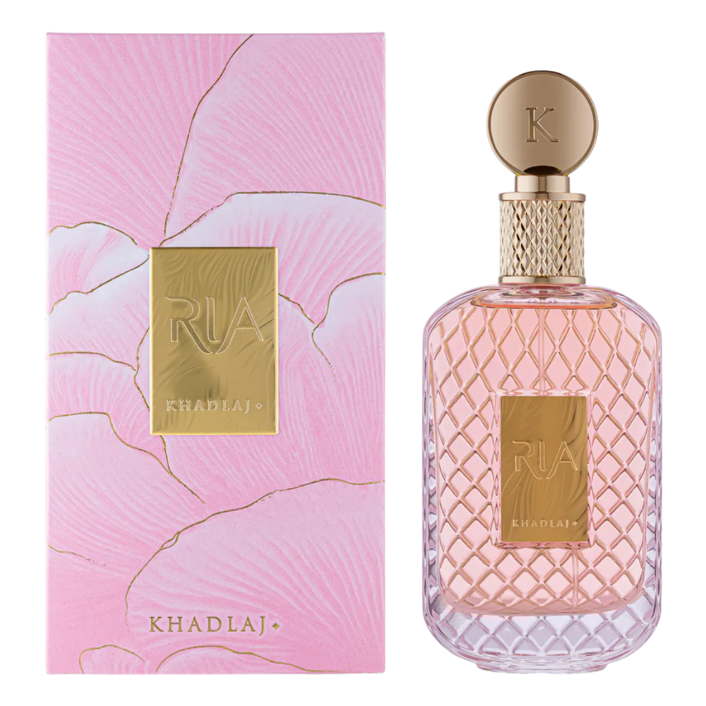 Elegant pink bottle and matching box of Ria EDP with gold accents, showcasing luxurious niche fragrance design.